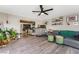 Spacious living room with gray sofa and a view into the dining area at 4818 El Tesoro Ave, Las Vegas, NV 89121
