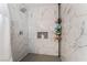 Clean shower with marble tile, built-in shelving, and a rainfall showerhead at 4818 El Tesoro Ave, Las Vegas, NV 89121