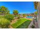 Landscaped backyard oasis with a built-in pool and spa at 4884 E Cactus Canyon Dr, Pahrump, NV 89061