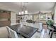 Open dining area with modern lighting and view into living room at 4884 E Cactus Canyon Dr, Pahrump, NV 89061