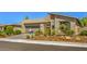 Modern home with a two-car garage and desert landscaping at 4884 E Cactus Canyon Dr, Pahrump, NV 89061