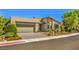 Modern home with a two-car garage and landscaped front yard at 4884 E Cactus Canyon Dr, Pahrump, NV 89061