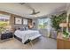 Spacious bedroom with wood-look accent wall and ensuite bathroom at 4884 E Cactus Canyon Dr, Pahrump, NV 89061