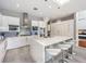 Modern kitchen with white cabinetry, stainless steel appliances, and a large marble island at 5 Clear Crossing Trl, Henderson, NV 89052