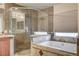 Bathroom with a walk-in shower and a granite-topped soaking tub at 6336 Fence Post St, Las Vegas, NV 89148