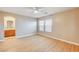 Primary bedroom with wood floors, ceiling fan, and en-suite bathroom at 6336 Fence Post St, Las Vegas, NV 89148