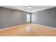 Simple bedroom with gray walls and light wood laminate flooring at 6336 Fence Post St, Las Vegas, NV 89148