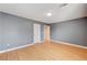 Simple bedroom with gray walls and light wood laminate flooring at 6336 Fence Post St, Las Vegas, NV 89148