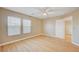 Bedroom with wood floors, ceiling fan, and two large windows at 6336 Fence Post St, Las Vegas, NV 89148