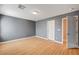 Gray walls and wood laminate flooring in this simple bedroom at 6336 Fence Post St, Las Vegas, NV 89148