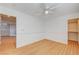 Spacious bedroom featuring wood floors, ceiling fan, and access to closet at 6336 Fence Post St, Las Vegas, NV 89148
