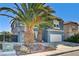 Two-story house with gray exterior, stone driveway, and palm trees at 6336 Fence Post St, Las Vegas, NV 89148