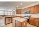 Kitchen with island, granite countertops, and wood cabinets at 6336 Fence Post St, Las Vegas, NV 89148