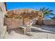 Relaxing patio with table and chairs under palapa at 6336 Fence Post St, Las Vegas, NV 89148