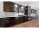 Modern kitchen features dark cabinetry, quartz countertops, and stainless steel appliances at 7220 Piute Mesa St, North Las Vegas, NV 89084