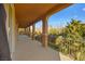 Covered balcony with arched columns and backyard view at 7258 Sashaying Spirit Ct, Las Vegas, NV 89131
