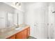 Clean bathroom with wood vanity, single sink, and large mirror at 7258 Sashaying Spirit Ct, Las Vegas, NV 89131