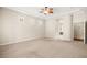 Bright bedroom with carpeting, ceiling fan, and en-suite bathroom access at 7258 Sashaying Spirit Ct, Las Vegas, NV 89131