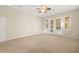Spacious bedroom with carpeting, ceiling fan, and double doors to patio at 7258 Sashaying Spirit Ct, Las Vegas, NV 89131