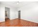Spacious bedroom with wood flooring and bathroom access at 7258 Sashaying Spirit Ct, Las Vegas, NV 89131