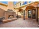 Outdoor fireplace and sitting area; elegant brick pavers and columns at 7258 Sashaying Spirit Ct, Las Vegas, NV 89131