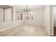 Elegant dining room with chandelier, large windows, and tile floors at 7258 Sashaying Spirit Ct, Las Vegas, NV 89131