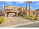 Two-story house with a three car garage and landscaping at 7258 Sashaying Spirit Ct, Las Vegas, NV 89131