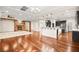 Open kitchen boasting dark cabinetry, granite counters, and hardwood floors at 7258 Sashaying Spirit Ct, Las Vegas, NV 89131