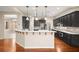 Modern kitchen with dark cabinetry, granite countertops and island at 7258 Sashaying Spirit Ct, Las Vegas, NV 89131