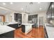 Modern kitchen with dark cabinetry, granite counters, and island at 7258 Sashaying Spirit Ct, Las Vegas, NV 89131