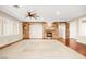 Living room featuring hardwood floors, stone fireplace, and ceiling fan at 7258 Sashaying Spirit Ct, Las Vegas, NV 89131