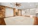 Spacious living room with hardwood floors, a stone fireplace, and a ceiling fan at 7258 Sashaying Spirit Ct, Las Vegas, NV 89131