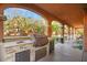 Outdoor kitchen with built-in grill, sink, and mini-fridge at 7258 Sashaying Spirit Ct, Las Vegas, NV 89131