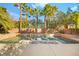 Refreshing pool with stone accents and palm trees at 7258 Sashaying Spirit Ct, Las Vegas, NV 89131