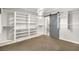 Large walk-in closet with ample shelving and sliding barn door at 7258 Sashaying Spirit Ct, Las Vegas, NV 89131