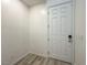 Bright entryway with a modern white door and wood-look flooring at 7322 N Decatur Blvd # 1, Las Vegas, NV 89131