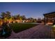 Landscaped backyard with covered patio and hot tub at 7620 Chase Hallow St, Las Vegas, NV 89149