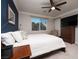 Primary bedroom with king-size bed and dark blue accent wall at 7620 Chase Hallow St, Las Vegas, NV 89149