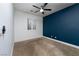 Bedroom with blue accent wall and ceiling fan at 7620 Chase Hallow St, Las Vegas, NV 89149