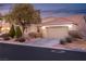 Beautiful two-story house with landscaped yard, attached garage, and inviting curb appeal at 7620 Chase Hallow St, Las Vegas, NV 89149