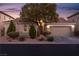 House exterior at night with landscaping and driveway at 7620 Chase Hallow St, Las Vegas, NV 89149