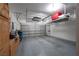 Garage interior with overhead storage and cabinets at 7620 Chase Hallow St, Las Vegas, NV 89149