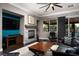 Bright living room featuring a fireplace, large windows, and comfortable furniture at 7620 Chase Hallow St, Las Vegas, NV 89149