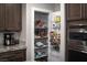Well-organized pantry with ample shelving for storage at 7620 Chase Hallow St, Las Vegas, NV 89149