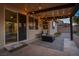 Covered patio with string lights, seating area, and access to the house at 7620 Chase Hallow St, Las Vegas, NV 89149