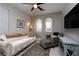Cozy sitting room featuring a comfortable sofa, armchair, and large TV at 7620 Chase Hallow St, Las Vegas, NV 89149