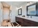 Elegant bathroom with dark brown vanity and a large mirror at 8068 Buena Vida St, Las Vegas, NV 89166