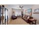 Relaxing Gathering room showcasing a brown leather sofa and large artwork at 8068 Buena Vida St, Las Vegas, NV 89166