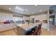 Modern kitchen with white cabinets, granite countertops, and an island at 8068 Buena Vida St, Las Vegas, NV 89166
