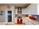Modern kitchen with white cabinets and a red oven at 8068 Buena Vida St, Las Vegas, NV 89166